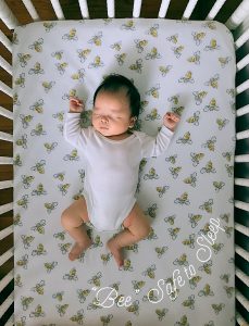 baby sleeping alone and on its back in a crib