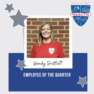 Image: Silver and blue box w photo of employee of the quarter and their name; silver stars; health department logo